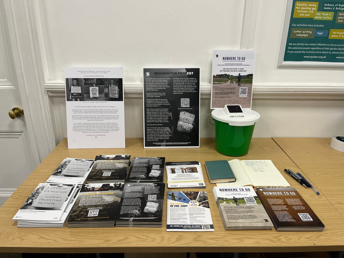 The printed materials set out at a showing: two A3 foam-board posters standing at the back, with stacks of A5 flyers laid out on the table to take away.